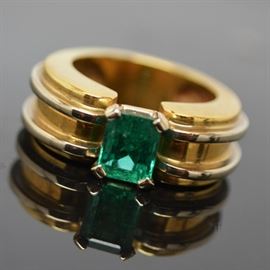 18K Yellow and White Gold 1.32 CTS Emerald Ring: An 18K yellow gold 1.32 cts emerald ring. This emerald ring features a white gold basket setting, with a white gold double ribbed design along the wide shank.