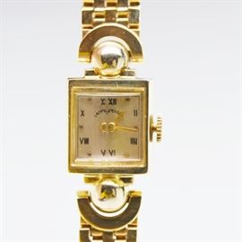 Retro Elgin 14K Yellow Gold Women's Wristwatch: A retro Elgin 14K yellow gold women’s wristwatch. Watch features a rectangular case with yellow gold bracelet.