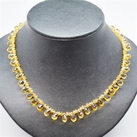 14K Yellow Gold Clasp Citrine Beaded Necklace: A 14K yellow gold clasp citrine bead necklace. Briolette citrine are each separated by two rondelle citrine beads along this necklace length.