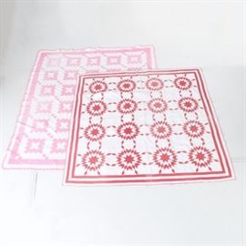 Vintage Quilts: A selection of vintage quilts. This selection includes a red and white handmade quilt with a star pattern and line border. Also in this selection is a pink and white handmade quilt with a square pattern with line border.