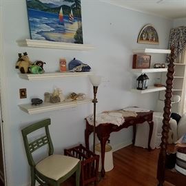 King bedroom view showing items on shelves, table with lace & doilies, etc.  Floor lamp is not for sale