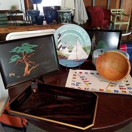 Round table displaying serving trays including two Couroc trays