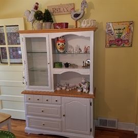 White cabinet.  Left side is lighted.  Decorative items