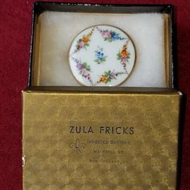 Hand-painted button in importer's box