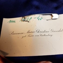 Tag or card pinned to the inside of the previous jacket