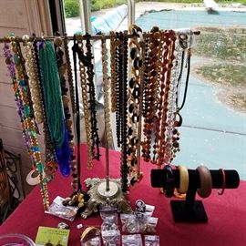 Costume jewelry necklaces & bangle bracelets.  Narrow red bangle is cinnabar 
