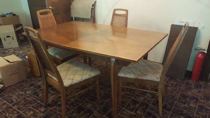 Mid-60's dining room table with four chairs and extra leaves   $150