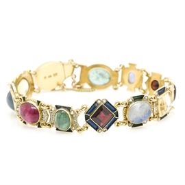 18K Yellow Gold Gemstone Bracelet: An 18 karat yellow gold link bracelet with citrine, pink and green tourmaline, blue sapphire, garnet, labradorite, iolite, and seed pearls.