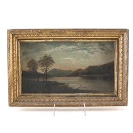 Framed Oil Painting on Board of a River: An oil painting on board of a river. This painting with impasto details depicts a large river traveling through a landscape filled with hills all under a cloudy sky. The painting is mounted in a gold tone wood frame with an elaborate plaster design. No signature is present to the painting.