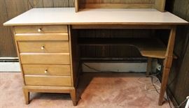 Vintage Haywood-Wakefield Desk
Measures 28"tall x 48"wide x 23 3/4"deep. Original pulls. 3 drawers slide very well. Lower shelf under desktop. Has a white top that appears to be original to the desk. Desk comes with non-original bookcase top, measures 4'tall x 28 1/2"wide x 10"deep. Desk is in very good condition, bookcase top is in good condition.
Matches slide-top dresser in lot 012.