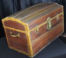 Antique Steamer Trunk
Clasp on front reads "Long Lock 1980" Comes with key. Trunk measures 19"tall x 30"wide x 17"deep. Brass handles each add 1 1/2" to width. Interior is beautifully lined with fabric, crafted from a previous owner.
Trunk contained swaths of fabrics that we are leaving within. Winning bidder may keep the fabric or not. Beautiful condition. This is a very exceptional piece.