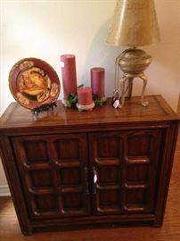 Console, decorative plate, candles, and darling lamp