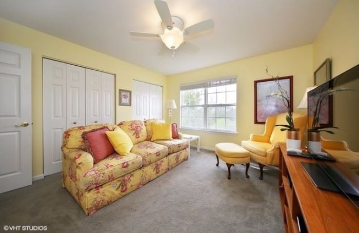 Beautiful sunny yellow print sofa and yellow high back chair with ottoman. 