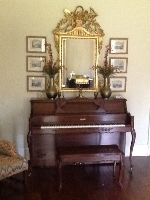 Beautiful ornate piano with matching bench. Note Chinese vases on top, brass music lamp, gilded mirror and framed artwork grouping.