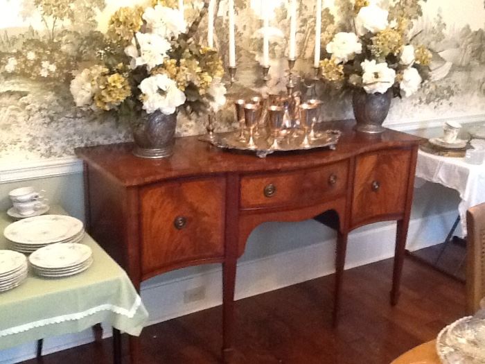 Gorgeous curved front sideboard. Note silver service on top. More sterling silver in the drawers.7