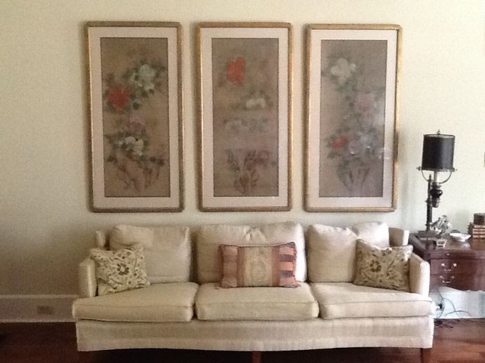 Large formal couch with decorative pillows. Take a look at the oriental framed silk panels hanging behind it. Rare find!!!