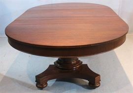 041a  Mahogany Empire dining table with column base, bun feet and 4 leaves with 2 skirted, 2 not skirted, 29 in. T, 88 in. L, 52 in. W.