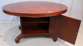 091b  Mahogany oval center table with storage compartment in base, 28 in. T, 51 in. W, 42 in. D.