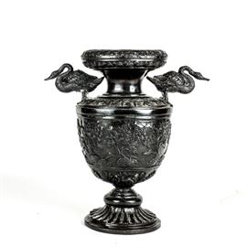 Japanese Meiji Period Bronze Swan Vessel: A Japanese Meiji Period メイジ (1868-1912) bronze vessel. This ornate depiction features a floral body, double handles in the form of swans, and a footed base.