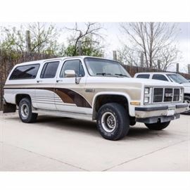 1987 GMC Sierra Classic SUV: A 1987 GMC Sierra Classic Suburban V1500; VIN is 1GKEV16K4HF520480 and mileage is at 105,644 (odometer goes up to 100,000 miles; has turned over and currently reads 5,644). The 4-door SUV is brown, tan and white. It features 4-wheel drive and has 4-speed automatic transmission with a 5.7 liter V8 190 HP engine. The wheel base is 129.5, with front and rear disc brakes. The truck comes with Michelin tires which appear to have adequate tread. There are steel running boards along the sides. The vehicle seats eight, and has tan cloth seats. Other features include a center console in the front, with a storage compartment and two cup holders, AM/FM radio, air conditioning, and power windows and door locks. The truck comes with two sets of keys and has clear title.