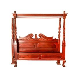 Chippendale-Style King Size Poster Bed Frame: A Chippendale-style king size poster bed frame with a mahogany finish. The headboard of this bed features a broken, scrolled pediment with a floral finial and carved foliate details. The bed features four barley twist posts with carved foliate and floral motifs and the low footboard rests upon cabriole legs with ball-and-claw feet. Side rails, slats, and a set of canopy rods are included.