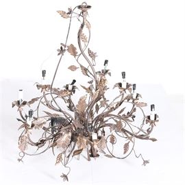 Foliate Style Chandelier: A foliate style chandelier. This chandelier features a twisted scrolling design with foliate style embellishments throughout. This piece has twelve sockets in a floral shape and features a chain for extending and connecting to the ceiling. Also included are a variety of colored glass attachments.