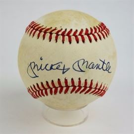 Signed Mickey Mantle Baseball COA: An autographed Mickey Mantle (1931-1995) Rawlings official American League baseball. The New York Yankees pen signed in blue between the red laces. The ball has a cushioned cork center. It comes with a COA from South Bay Baseball Cards, Inc., and clear plastic case.