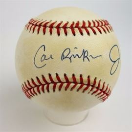 Signed Cal Ripken Jr. Baseball COA: An autographed Cal Ripkin, Jr., Rawlings official National League baseball. It is pen signed in blue between the red laces. The ball has a cushioned cork center. It comes with a COA from South Bay Baseball Cards, Inc., CA, and clear plastic case.