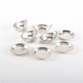 Gorham Sterling Silver Nut Dishes With Additional Sterling: A group of eight sterling silver nut dishes. There are four Gorham A4775 pierced dishes with beaded edges. Additionally, there are four Revere Silversmiths round dishes with gadroon trim.