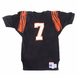 Boomer Esiason Signed Vintage Koch/Russell Jersey: A vintage Boomer Esiason autographed Cincinnati Bengals jersey. Boomer personalized his signature to “Bill Best Wishes” in the top bar of the “7” and Boomer signed his name on the larger part of the “7”; the writing was done with a black marker. Boomer signed the “7” on the front of the jersey. The jersey has the tags from Koch Sporting Goods and Russell Athletic; the size tag of 44 is to the right of the Russell Athletic label. The jersey has been worn.