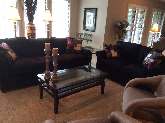 Charcoal ultrasuede sofas, beveled glass Asian motif coffee table, pair of sleek upholstered occasional chairs 