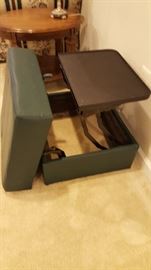 Green foot stool, opens with pull up table.