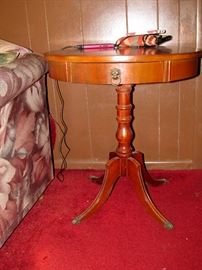 Sweet round table with a lion pull drawer