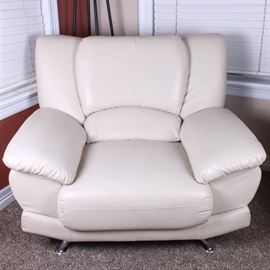 Contemporary Faux Leather Armchair: A contemporary faux leather armchair. The large, overstuffed armchair is thickly padded, and is upholstered in white faux leather. It rests on chromed metal legs, and is labeled “Imported by Global Furniture USA” and “Made in China”. Please note, this item is located on an upper floor.