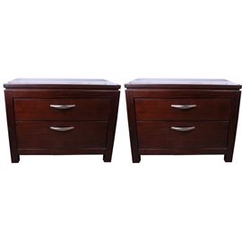 Pair Contemporary Nightstands by B.K. Home Furniture: A pair of contemporary nightstands by B.K. Home Furniture. The matching night stands are made of a dark stained wood. They feature rectangular tops, with straight sides and square, straight legs. The night stands have two dovetailed drawers, each fitted with a brushed chrome metal handle. The backs are labeled “B.K. Home Furniture”. One nightstand is marked with “Item # 1866-1121”. The label states that the night stands were manufactured in 2009. This item matches item 17DEN021-003 and 006. Please note, this item is located on an upper floor.