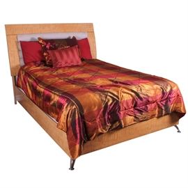 Contemporary Bed by Signature Design: A contemporary full-size/double bed, with bedding. The bed is made of engineered wood, with a laminate surface, featuring faux maple wood grain. The rectangular headboard has a padded and upholstered piece in the center. The bed includes a headboard and three side rails, and it rests on chrome finished metal legs. Included with the bed is a silky red, orange and bronze tone comforter, a fitted sheet, a flat sheet, three pillow cases and an accent pillow. This item matches item 17DEN021-007 and 17DEN021-010. Please note, the mattress is not included. This item is located on an upper floor.