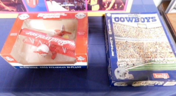 Dallas Cowboys puzzle and Budweiser toy plane