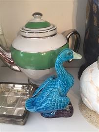 Teapot and bird figurine
