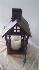 Battery operated candle in a bird house