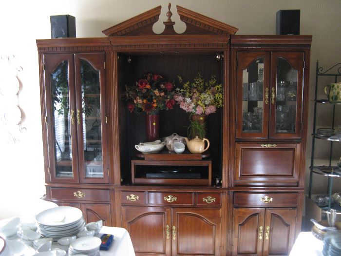 Beautiful wood entertainment center - lighted hutch in 3 pieces. Glass, drawers and lower cabinets.