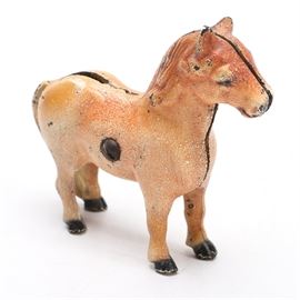 Vintage Shetland Pony Cast Iron Bank: A shetland pony cast iron bank. The pony is brown with a slot on its back to insert coins. It is held together with a screw in the center.