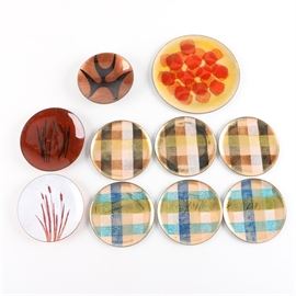 Retro Enameled Dishes: A selection of retro styled enameled dishes. Each of the dishes has different colors and patterns. There are two sets of three with plaid patterns in warm and cool colors, two with more linear designs, one with an abstract asymmetrical piece, and the largest with a red and yellow blotted design.