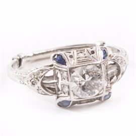 Vintage Edwardian Style Platinum and 0.94 CTW Diamond Ring: A vintage Edwardian style platinum ring with an 0.80 ct center diamond surrounded by twelve single-cut diamonds accented with simulated blue stones.