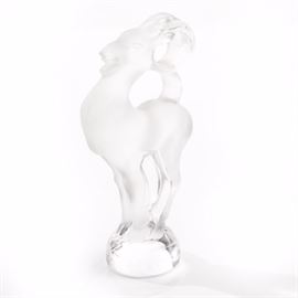 Lalique Ram Cachet: A small crystal ram cachet by Lalique. The figure has a satin finish and is mounted on a round base. The figure is etched “Lalique France” to the edge of the base.