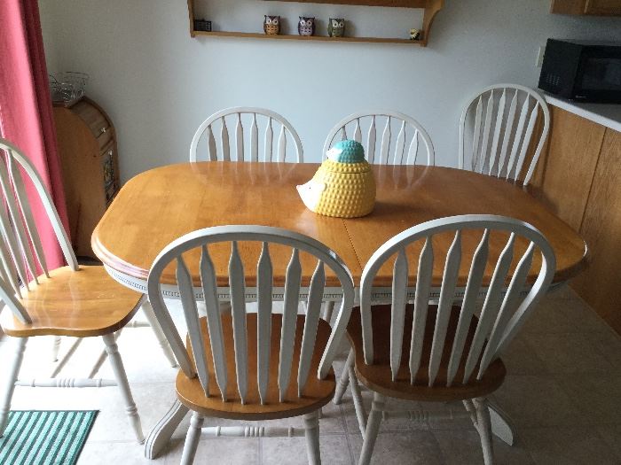 country French dining table has six chairs and two stowed leaves