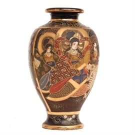 Antique Japanese Satsuma Kinkozan Vase: A Japanese Satsuma ware vase produced by the Kinkōzan pottery. This distinctive vase features a serene domestic scene with ladies in elaborate dress, a child and a dragon. The opposite side of the vase depicts a fighting scene between a dragon tail and a youth against a blue-black ground with applied scale embellishments. The vase has golden accents and hand-applied embellishments throughout. It is marked to the underside “Kinkōzan, Made by Asanō” (金光山淺野造) underneath a Shimazu mon. It likely dates from the late 19th century or early 20th century.