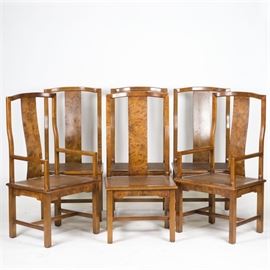 Vintage Yoke Back Dining Chairs: A set of vintage yoke back dining chairs. These six matching chairs feature curved splat backs with a burl veneer finish and woven cane seats over side aprons rising on straight legs joined by an H-stretcher. Two of the four chairs have armrests. There are no visible maker’s marks or labels on this piece.