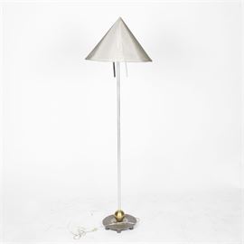 Conical Shade Floor Lamp: A conical shade floor lamp. This vintage floor lamp features a gray fabric shade in a round cone shape with a pointed top. The lamp also has prisms hanging just below the light socket, a silver tone pole body and a round gold tone and gray base. This piece has no apparent marks.