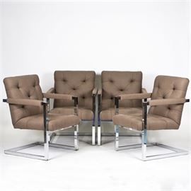 Mid Century Modern Upholstered Chairs: A set of Mid Century Modern upholstered chairs. This collection of four chairs with a brown upholstered tufted seat and back with matching armrests rises on chrome legs. These chairs are labeled “Made In Italy” to the underside.