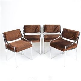 Chrome and Velour Lounge Chairs: A set of chrome and velour lounge chairs. The four chairs in this set each have rectangular tube frames with brown velour upholstered seats and backs featuring low-slung armrests. The chairs are not brand labeled.